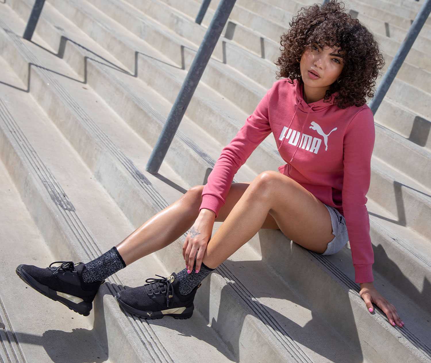 Sporty young woman wearing all puma sport clothes and shoes.