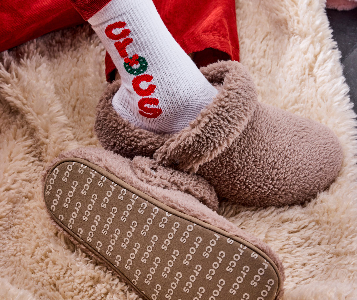 womens fuzzy crocs classic clog walking on sidewalk.